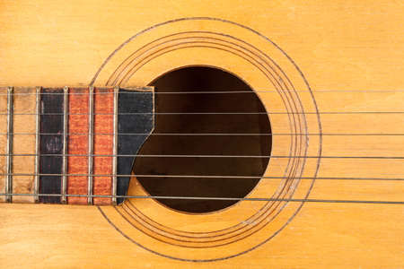 Acoustic guitar resting on color background with copy space. Modern concept