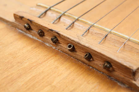 Acoustic guitar resting on color background with copy space. Modern concept