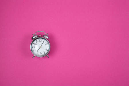 Clock on violet background. Place for textの写真素材