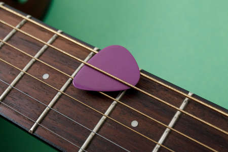 Acoustic guitar resting on color background with copy space. Modern conceptの写真素材
