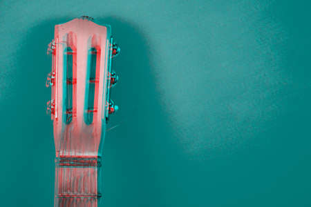 Glitch effect. Acoustic guitar resting on color background with copy space. Modern conceptの写真素材