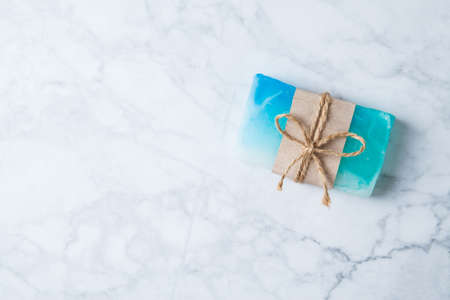 fragrant handmade soap lies on a circular base on a wooden backgroundの写真素材