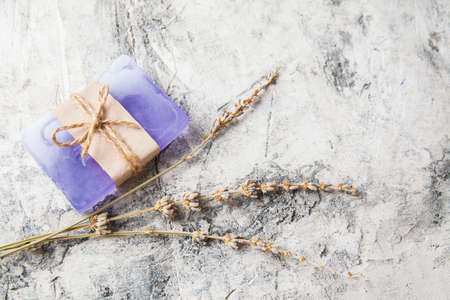 fragrant handmade soap lies on a circular base on a wooden background