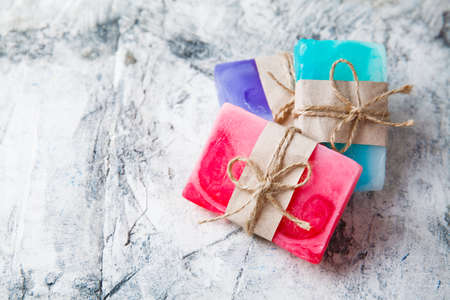 fragrant handmade soap lies on a circular base on a wooden backgroundの写真素材