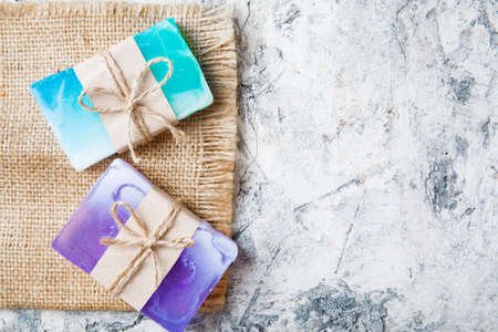 fragrant handmade soap lies on a circular base on a wooden backgroundの写真素材