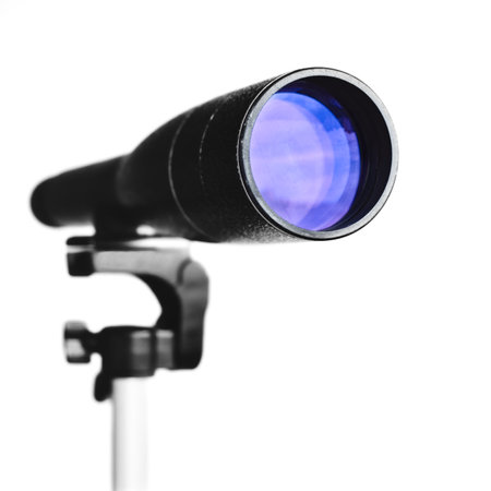 Spyglass or telescope on tripod isolated on white background. Close-up view on telescope lens. Selective focus.の写真素材