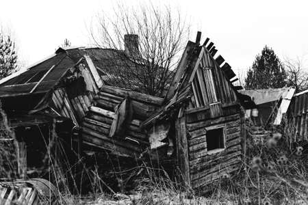 Old destroyed abandoned wooden house. Monochrome style black and white photo.の写真素材
