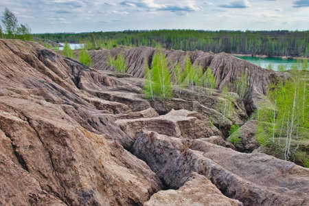 Beautiful natural relief landscape with green birches on the quarry hills in spring. Konduki, Tula Region, Russia.の写真素材