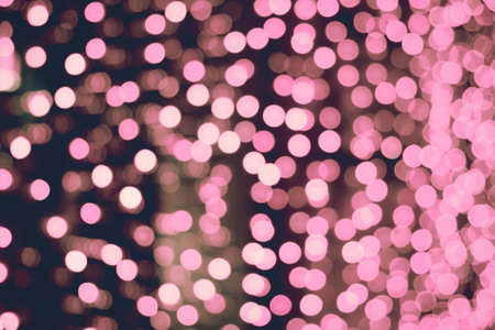 Abstract background with pink blurred lights. Bokeh effect. Festive colors. Christmas celebration...