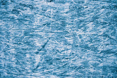 Blue tone ice texture. Skate marks on the ice. Winter outdoor skating. Abstract background.の写真素材