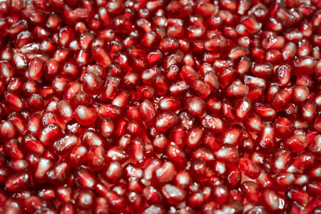 Close-up of fresh and ripe pomegranate seeds. Texture of pomegranate seebs as background.の写真素材