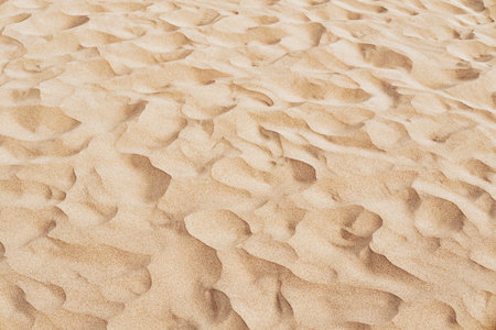 Natural sand texture. Wavy sand background for summer designs.