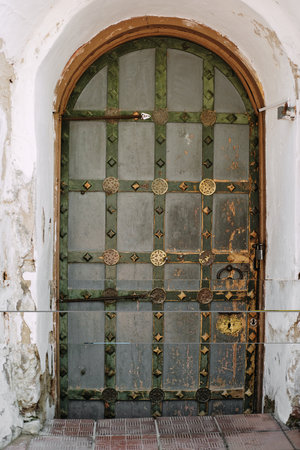 Ancient door in the shape of an arch.の写真素材