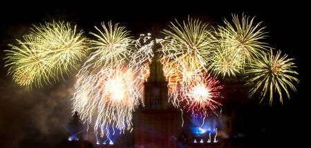 Fireworks over the roofs of buildingsの写真素材