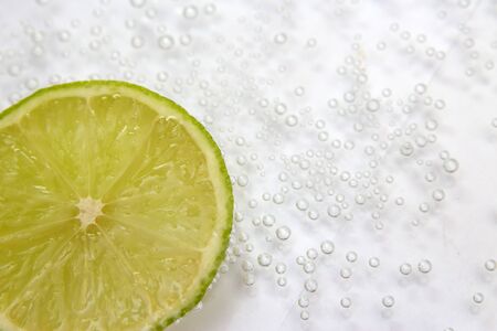 Bubbles into lobules of lime on white backgroundの写真素材