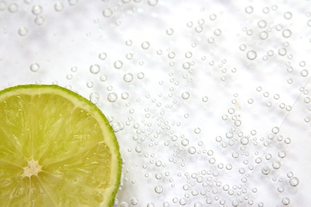Bubbles into lobules of lime on white backgroundの写真素材