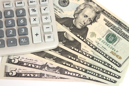 Calculator on twenty dollar bills isolated on white backgroundの写真素材