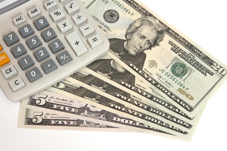 Calculator on twenty dollar bills isolated on white backgroundの写真素材