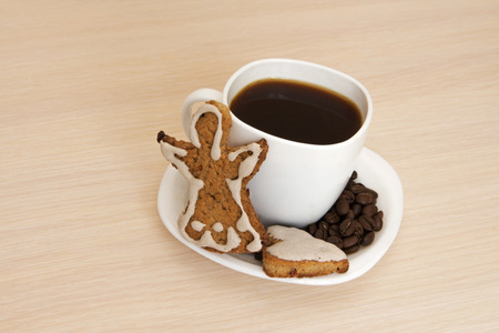 Cup of coffee with cookies on a wooden backgroundの写真素材