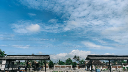 Sunny Village Scene with Clear Sky and Clouds
