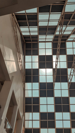 A ceiling structure featuring evenly spaced square windows that let in natural light