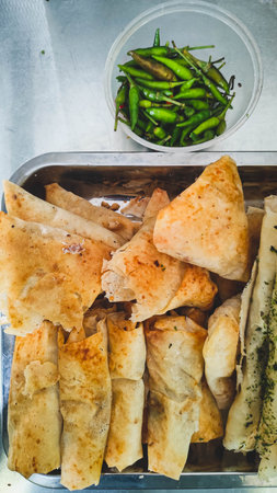 A tray filled with various types of crispy fried food placed on a tableの写真素材