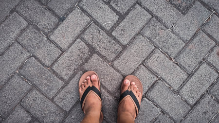 Overhead Bare Feet Flip-Flops Herringbone Walkwayの写真素材