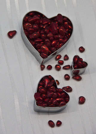 Three hearts filled with red decorative stones の写真素材