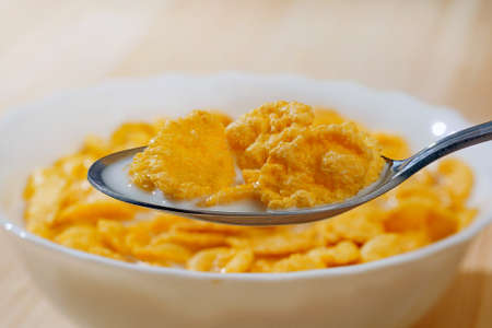 closeup of cereals with milk on a spoon