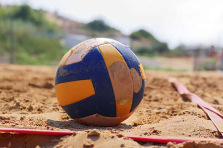 shabby beach volleyball game ball on sand playgroundの写真素材