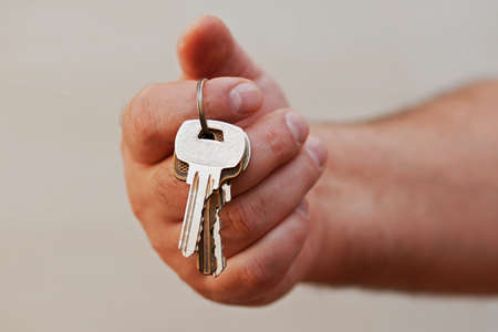 closeup of hand giving keys on ringの写真素材