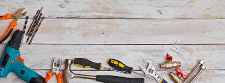 top view of set of hand tools on wooden background with copy space, suitable for header or banner