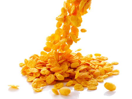 closeup of falling corn flakes isolated on white background