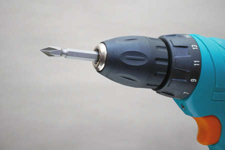 closeup of electric drill chuck on grey backgroundの写真素材
