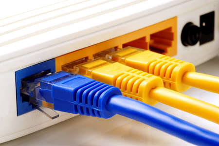 close up on three network cables connected to WAN and LAN ports on routerの写真素材
