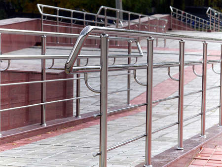 wheelchair ramps closeup with steel handrails in city parkの写真素材