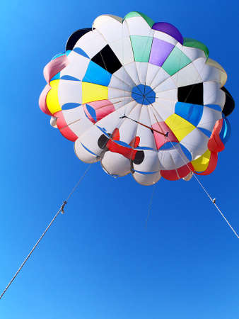 parasailing parachute against blue sky, bottom viewの写真素材