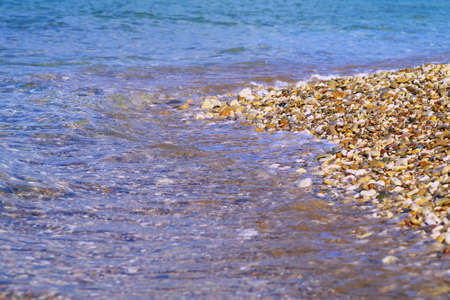 closeup on sea waves on pebble beachの写真素材