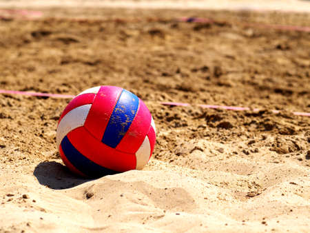 Beach volleyball game ball on sandの写真素材