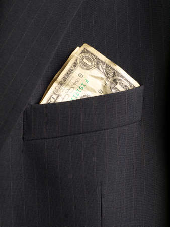 crumpled shabby one dollar banknote in a chest pocket of business suit, closeupの写真素材