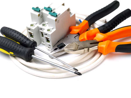 set of electrician tools and equipment and a coil of wire on a white background, focus on cutterの写真素材