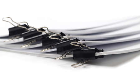 several stacks of paper held by binder clips, shallow depth of fieldの写真素材