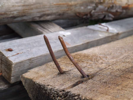 Two rusty curved nailsの写真素材
