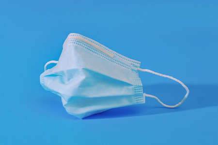 closeup of protective face mask on blue background