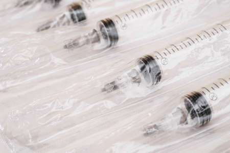 closeup of plastic disposable syringes in a blister pack