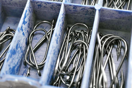 Macro of assorted fishhooks. Set of fishing hooks in tackle box.