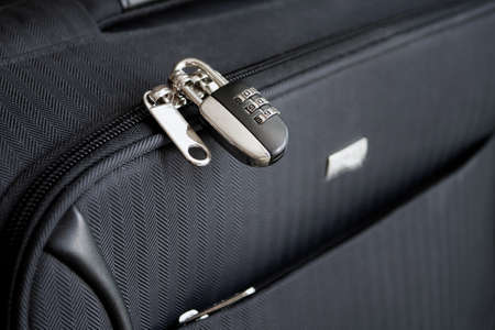 Closed combination lock on suitcase. Closeup of padlock locked on case, Safe travel concept.の写真素材