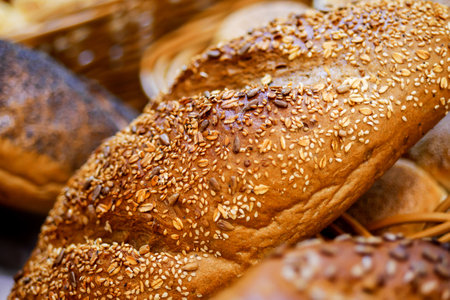 Closeup of loaf of bread with various seeds, Homemade bread. Fresh baked bread in baker shop.