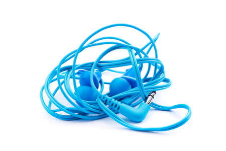 Blue earbuds isolated on white background. Tangled and twisted wire headphones.