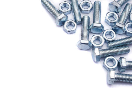 Screws and nuts on white background. Industrial background. Top view on various fasteners with copy...